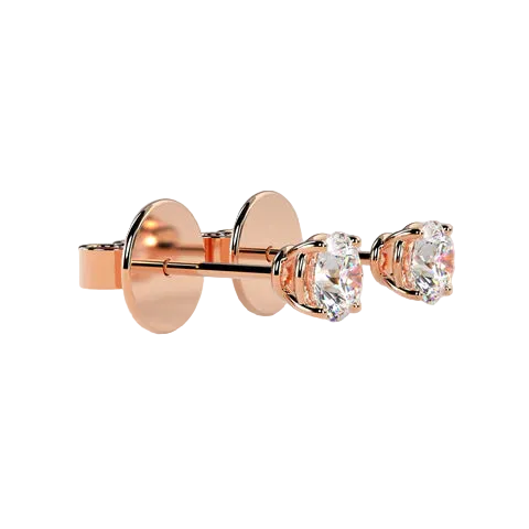 Rose gold stud earrings with oval-cut clear gemstones in a prong setting, shown on a soft beige background.
