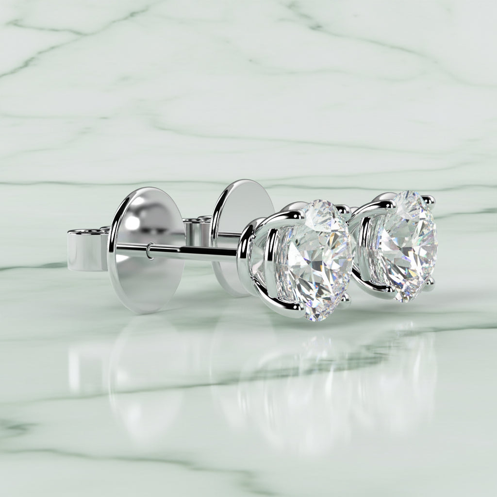 Diamond stud earrings on a light beige background