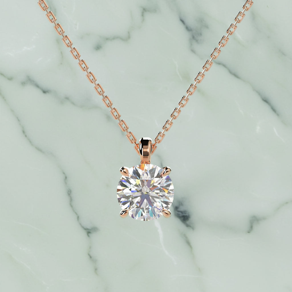 Rose gold necklace with a diamond pendant on a light beige background