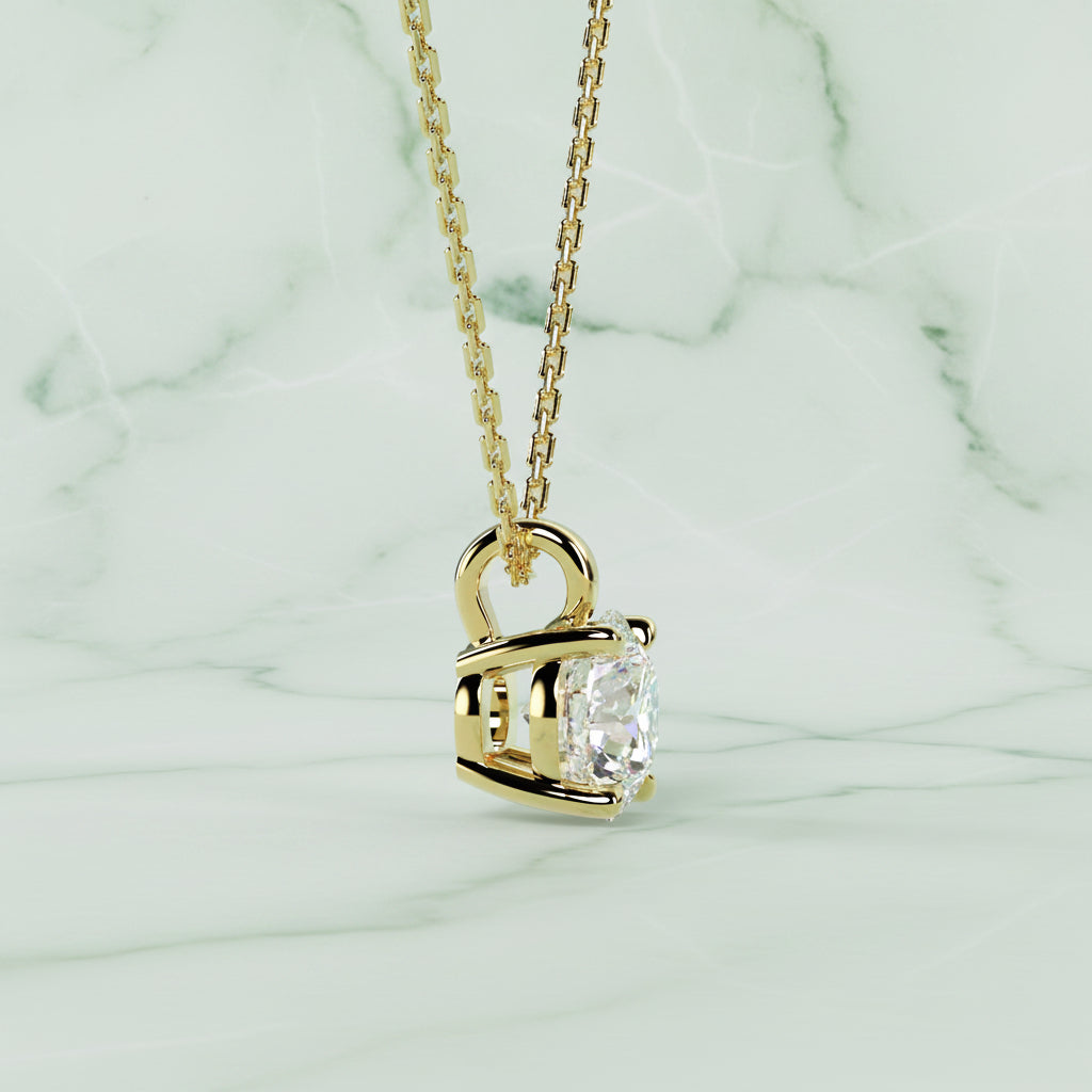 Gold necklace with a diamond pendant on a beige background