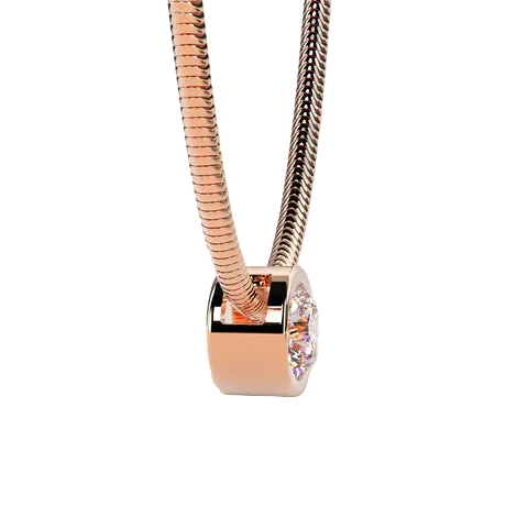 A close-up of a snake chain necklace with a polished rose gold cylindrical charm featuring a clear faceted gemstone, set against a solid light beige background.