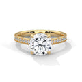 Gold ring with a large diamond and smaller diamonds on the band against a white background