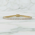 Gold bracelet with diamonds on a beige background