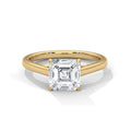 Gold ring with a large diamond on a white background