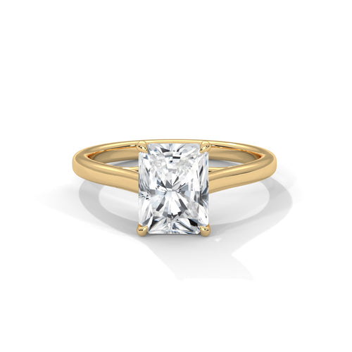 Rose gold ring with a clear gemstone on a white background