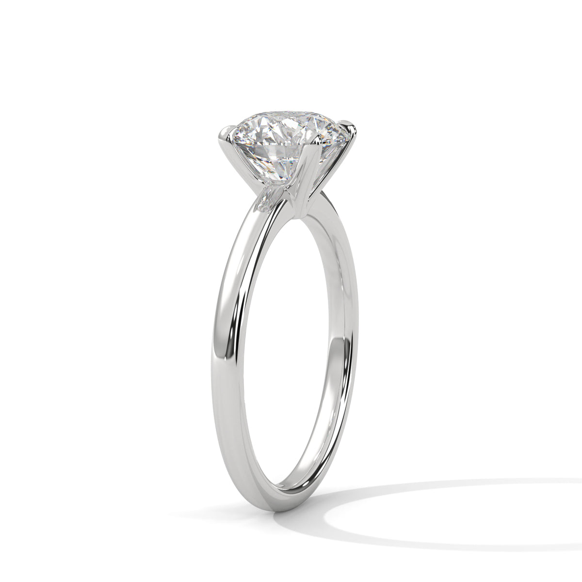 A classic solitaire engagement ring featuring a round brilliant-cut diamond set in a polished white gold or platinum band, shown on a clean white background with a soft shadow.
