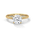 Gold ring with a diamond on a white background