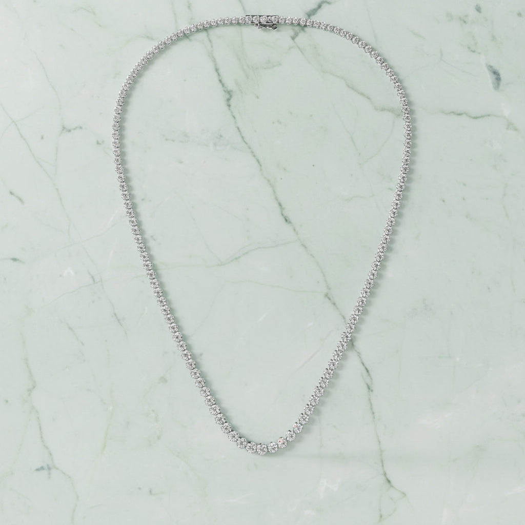 Silver necklace on a light beige background