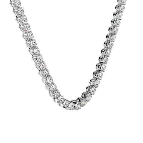 A close-up of a silver-toned tennis necklace with clear round-cut stones, arranged in a U-shape against a solid pale beige background.