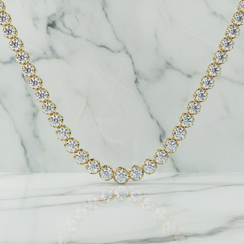Gold necklace with clear gemstones on a beige background
