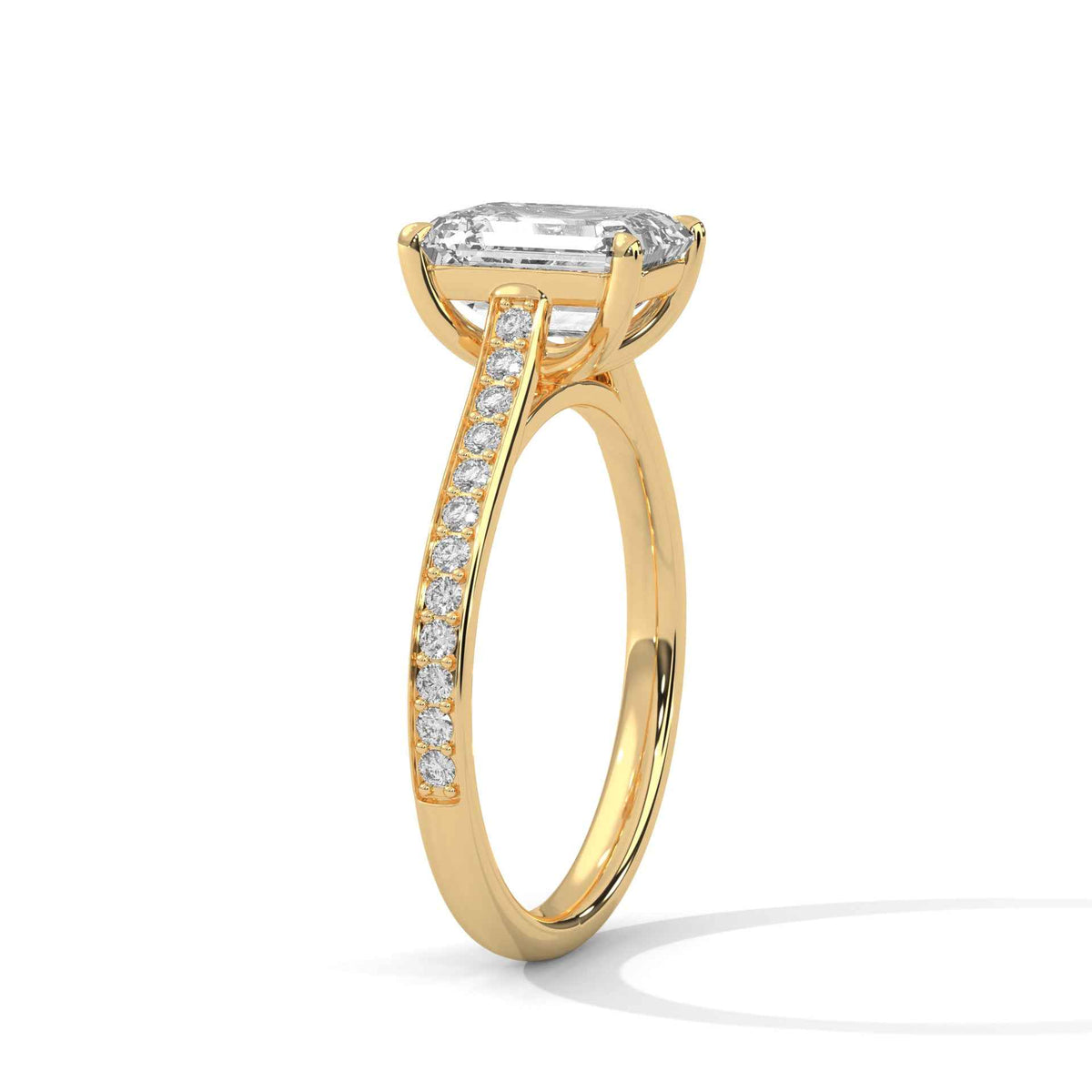 A yellow gold engagement ring featuring a large rectangular emerald-cut diamond center stone and a pavé-set diamond band, shown on a clean white background.