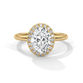 Rose gold ring with a large diamond and smaller diamonds on the band against a white background