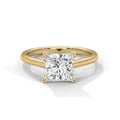 Gold ring with a square-cut diamond on a white background