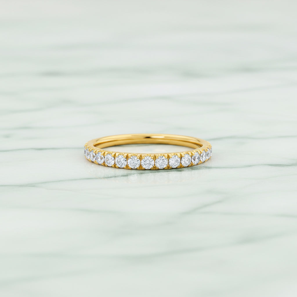 Gold ring with diamonds on a white background