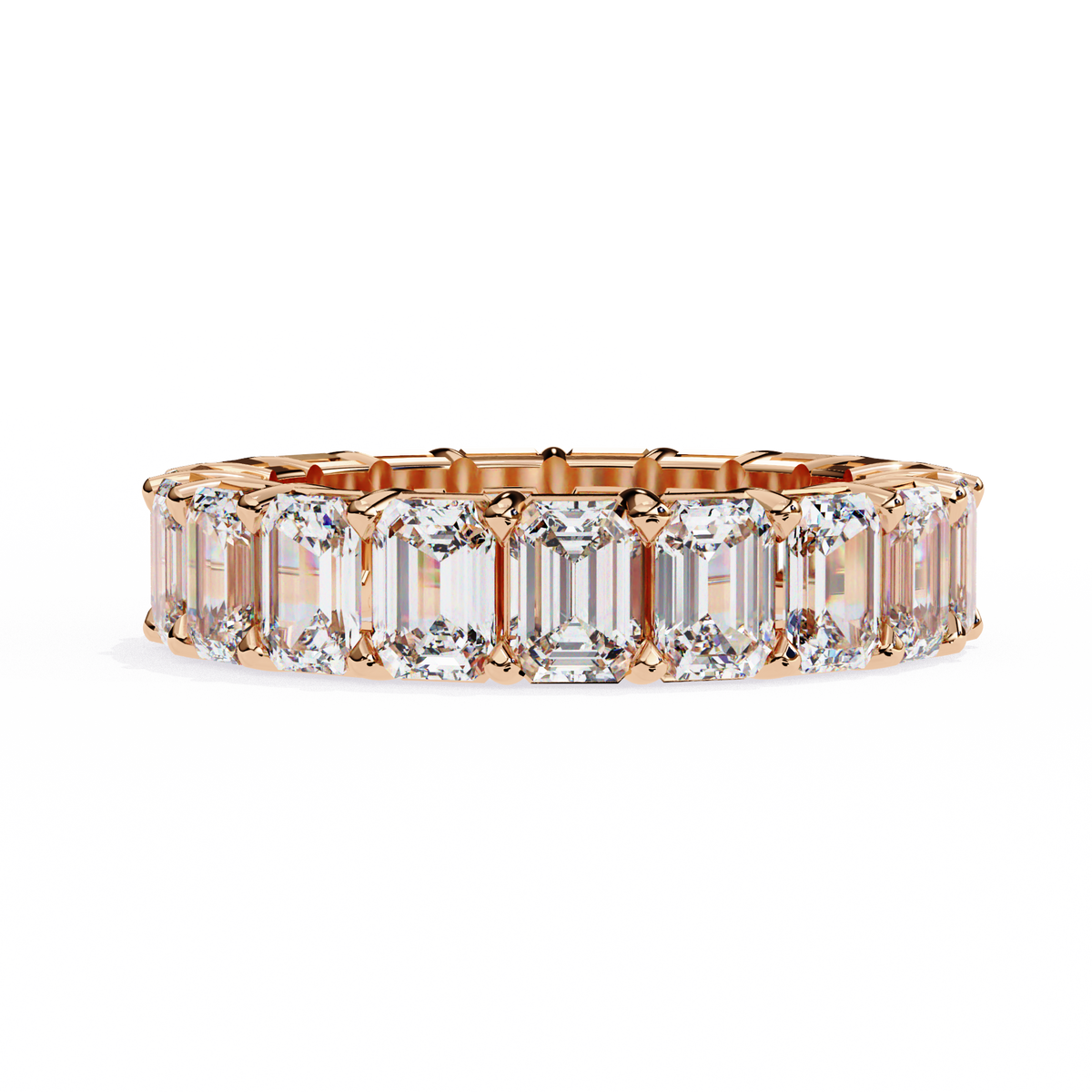Gold ring with emerald-cut diamonds on a white background