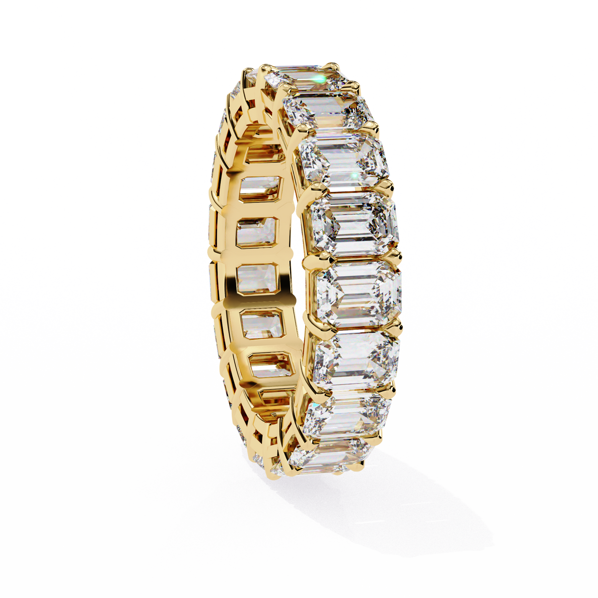 Gold ring with emerald-cut diamonds on a white background