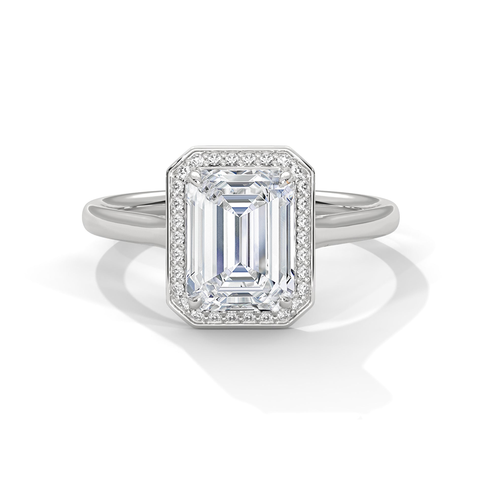 Gold ring with emerald-cut diamond and smaller diamonds on a white background