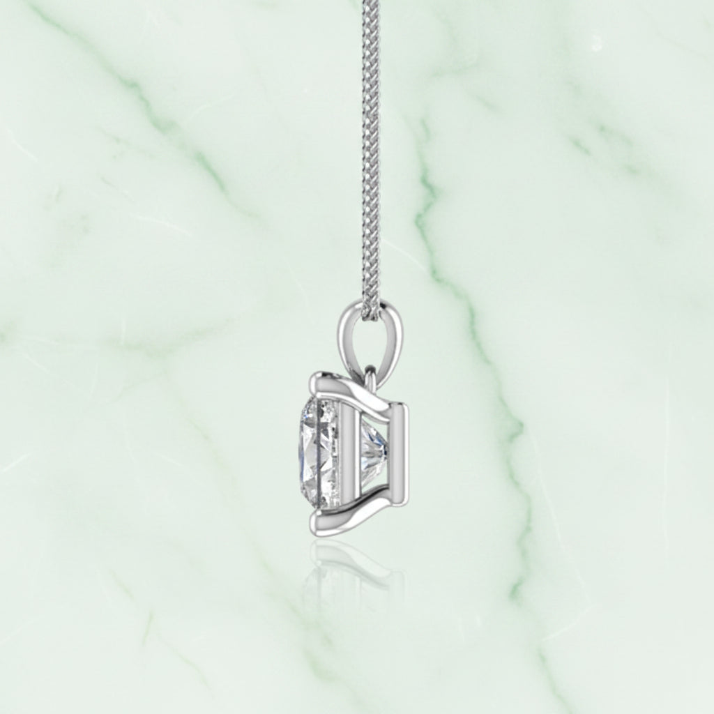 Diamond pendant on a chain against a white background
