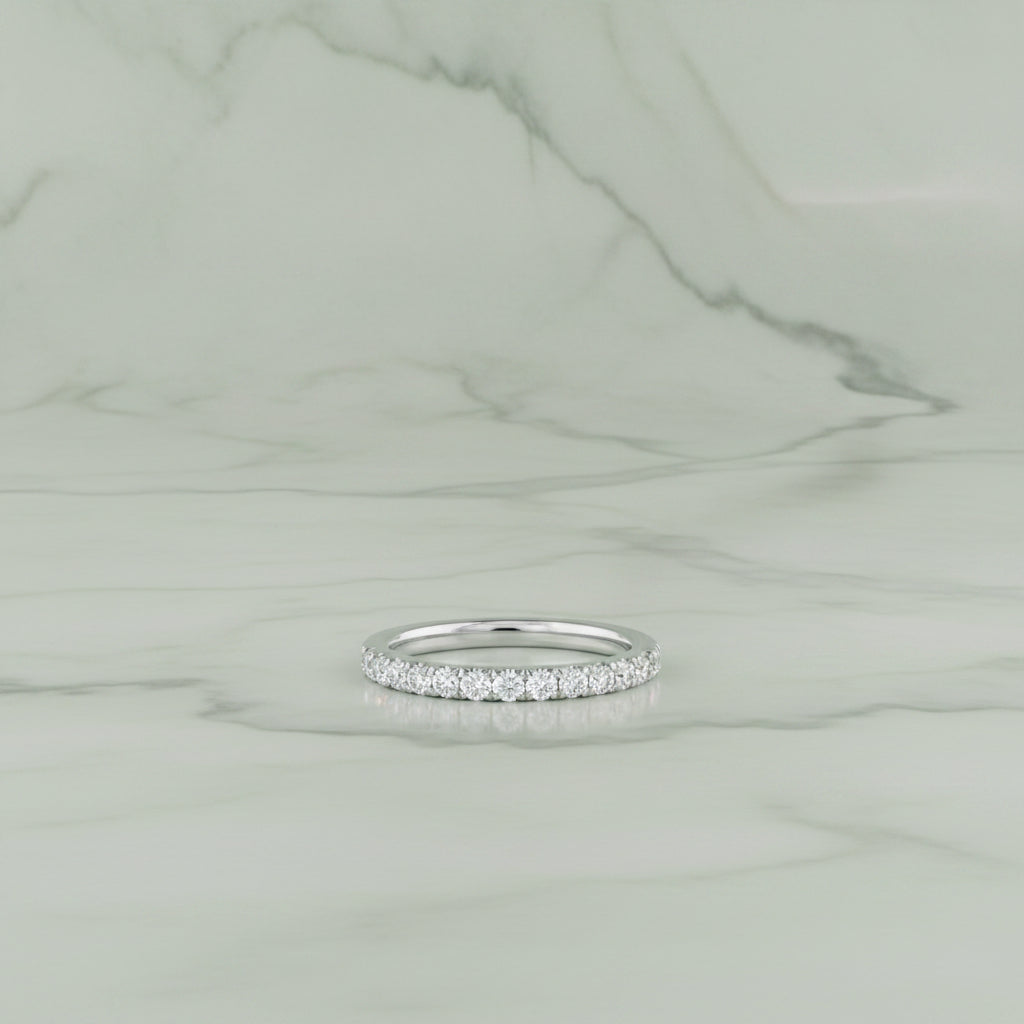 Silver ring with small diamonds on a white background