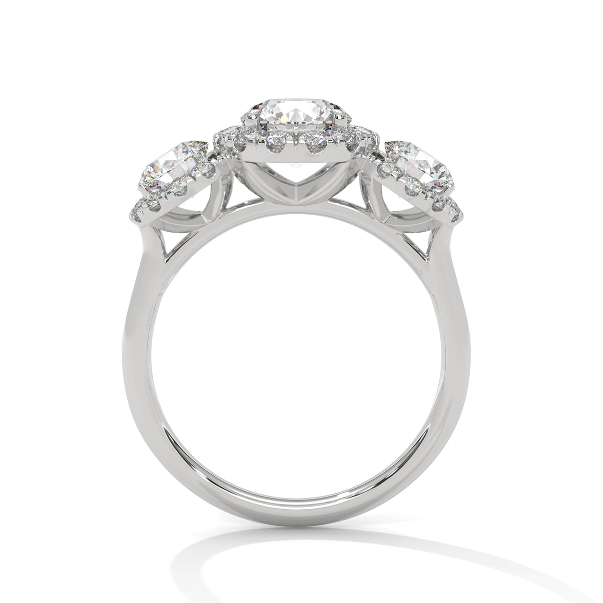 Silver ring with three circular gemstones on a white background