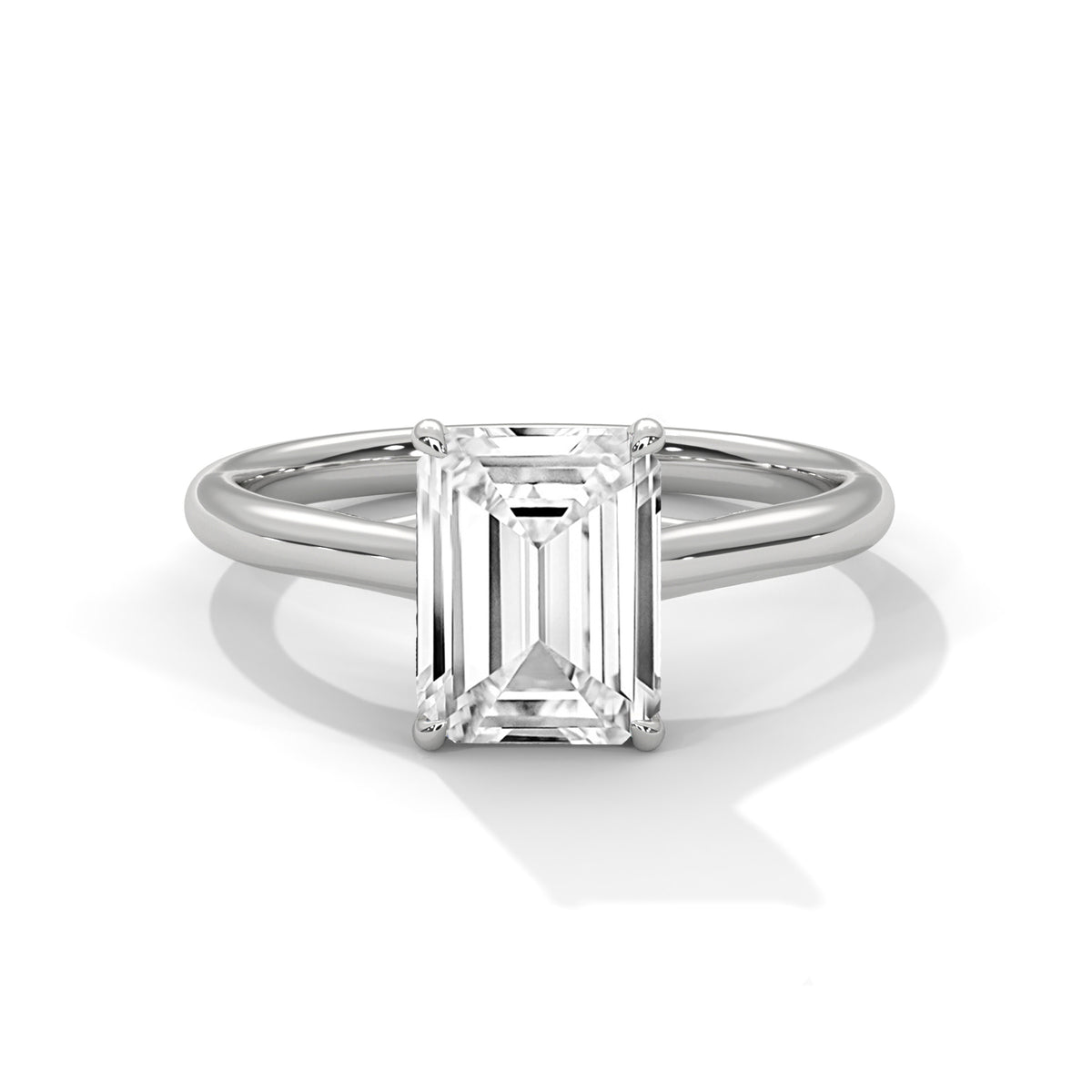 Diamond ring with emerald-cut gemstone on a white background