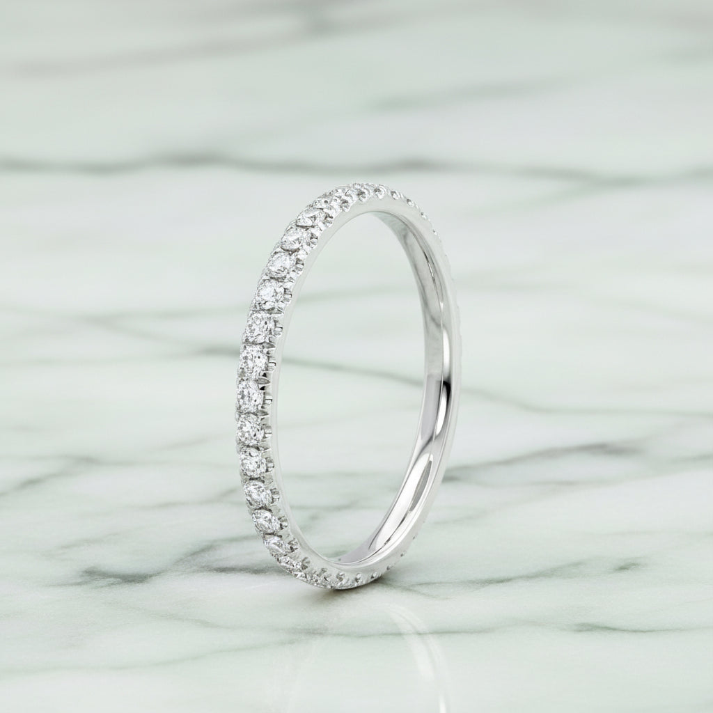 Silver ring with small diamonds on a white background