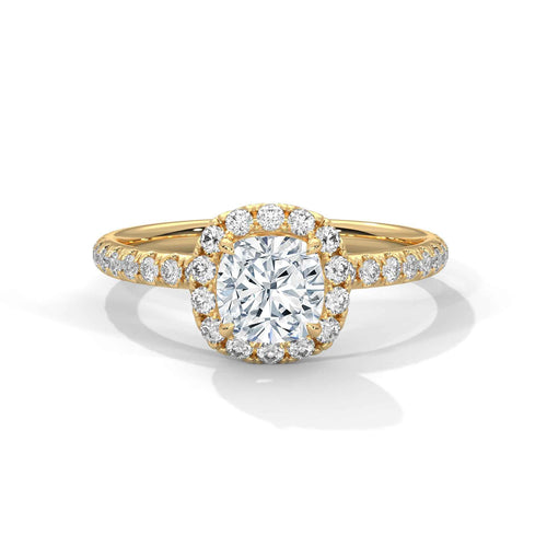 Gold ring with a large diamond and smaller diamonds on the band against a white background