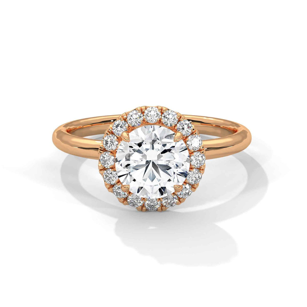 Rose gold ring with a large diamond and smaller diamonds around on a white background