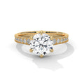 Gold ring with a large diamond and smaller diamonds on the band against a white background