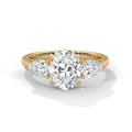 Gold ring with a heart-shaped diamond and smaller side stones on a white background