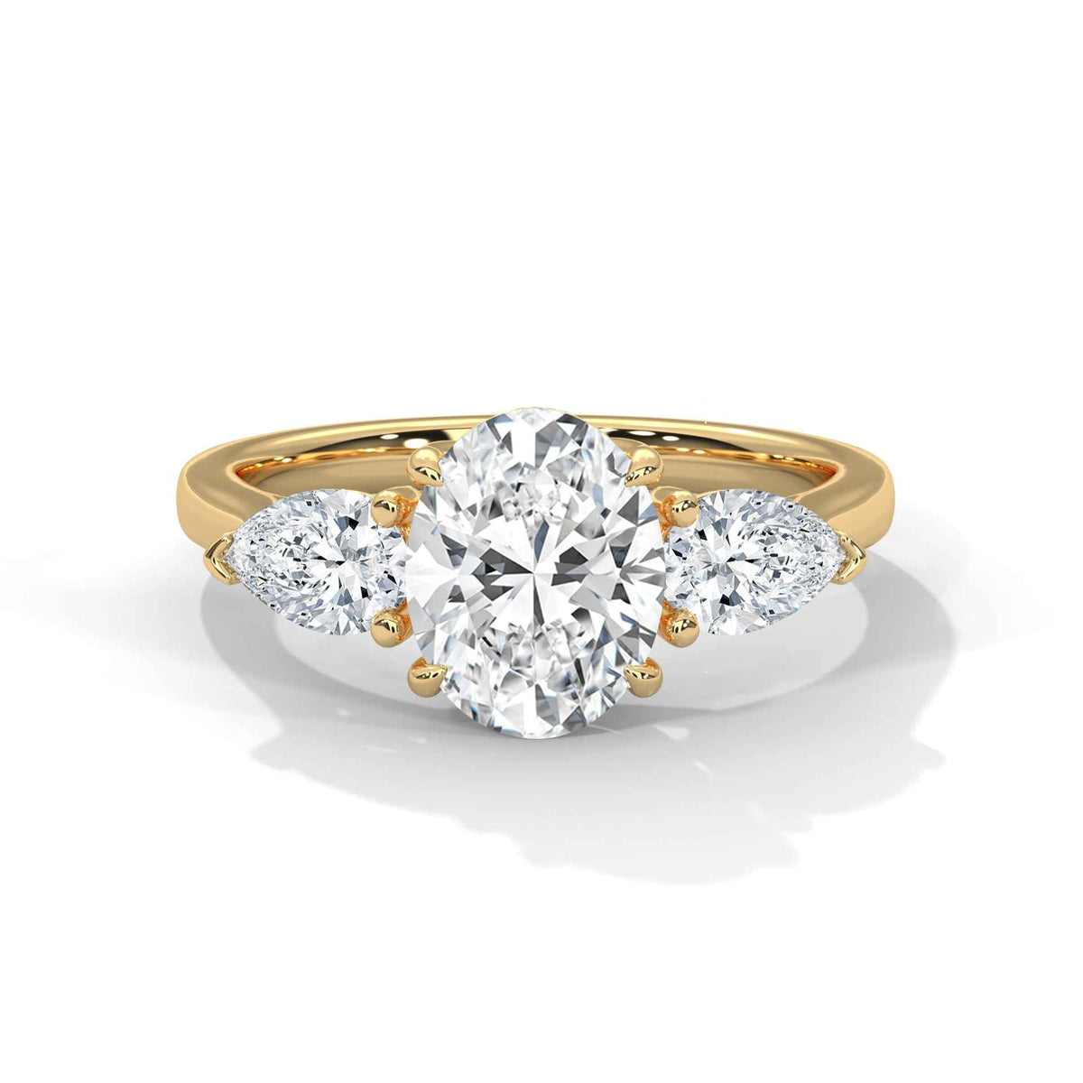 Gold ring with a heart-shaped diamond and smaller side stones on a white background