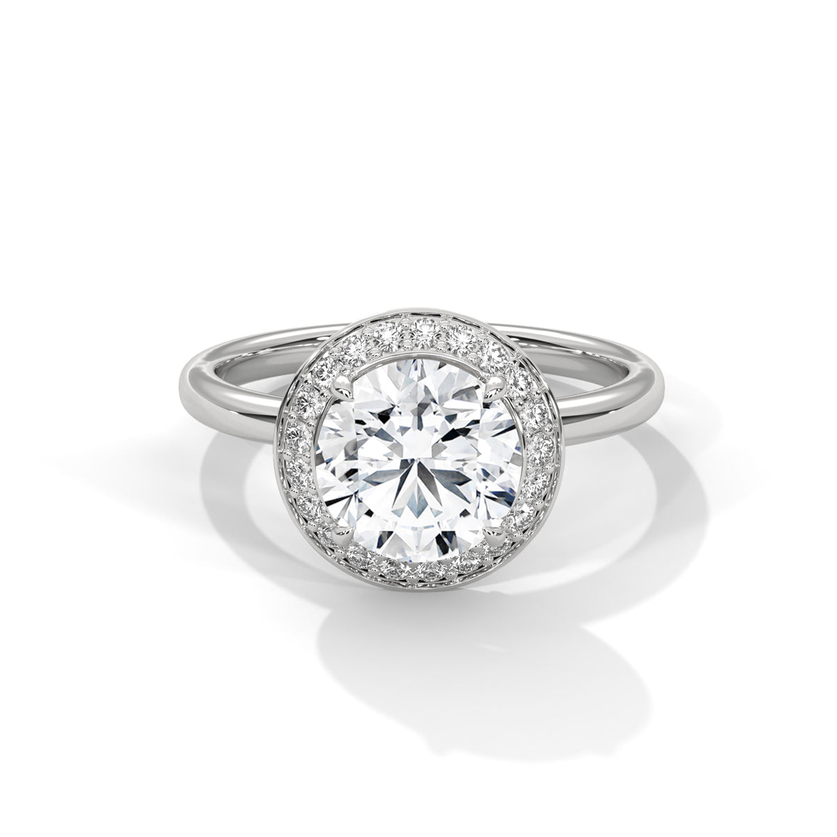 Diamond ring with a halo setting on a white background
