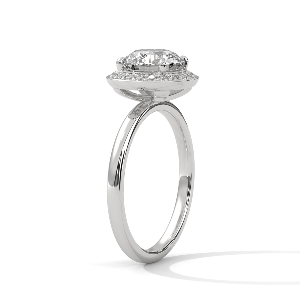 Diamond ring with a halo setting on a white background