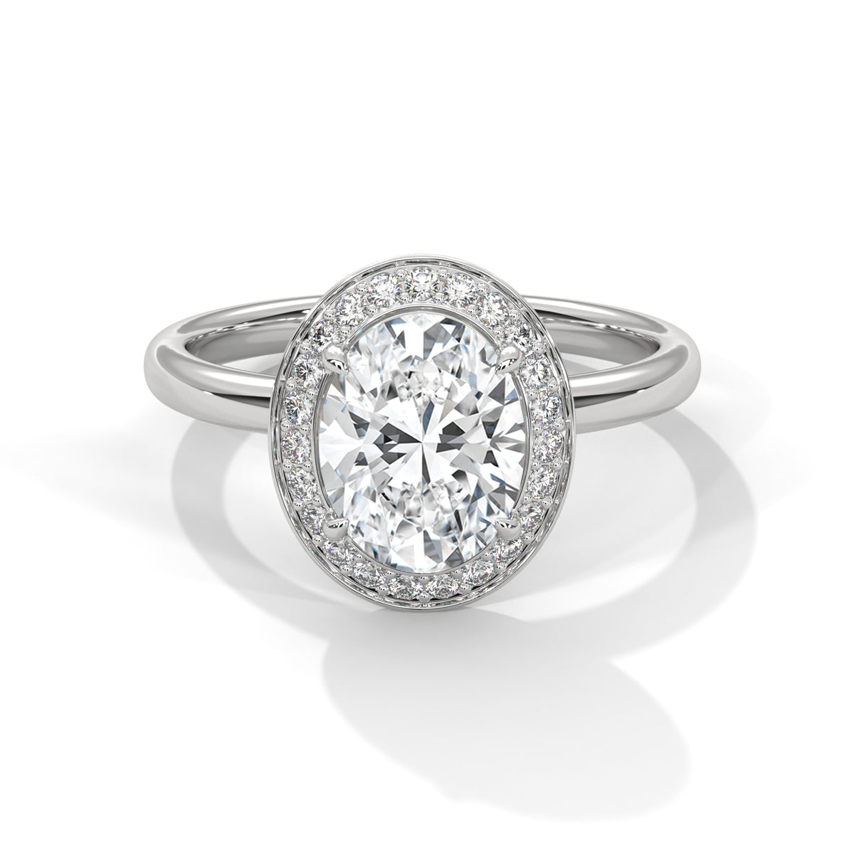 Diamond ring with a halo of smaller diamonds on a white background