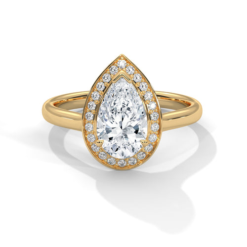 Gold ring with a pear-shaped diamond and smaller diamonds on a white background