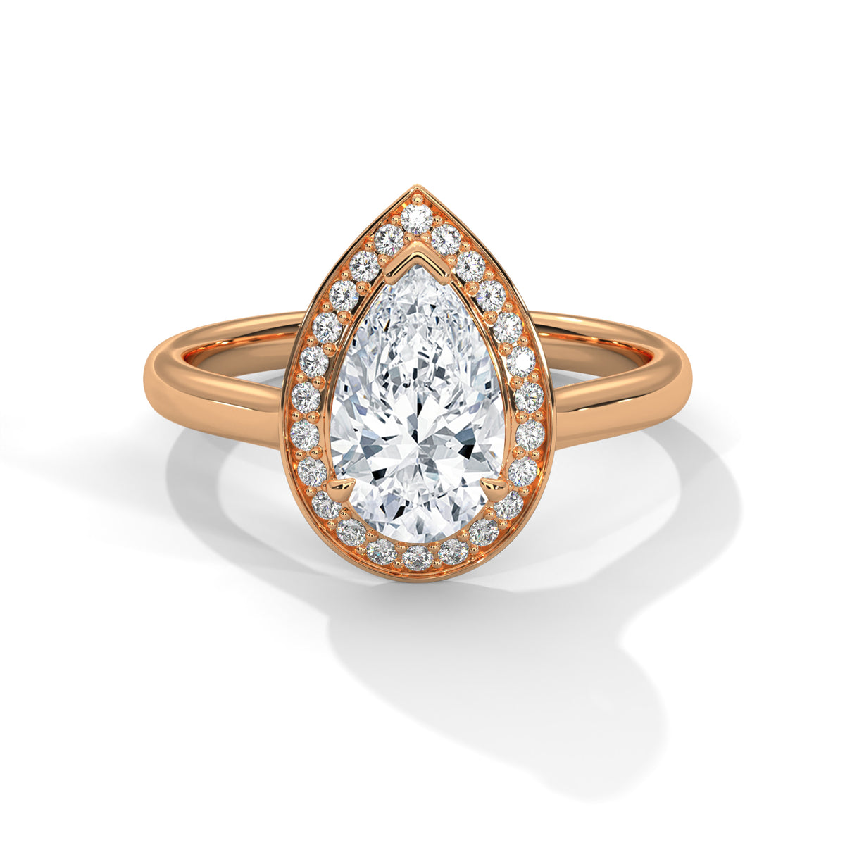 Rose gold ring with a pear-shaped diamond on a white background