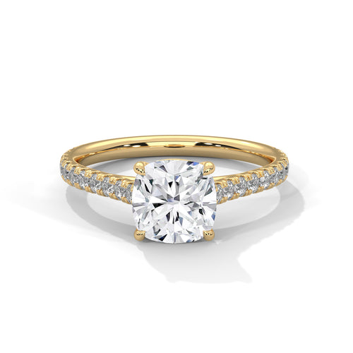 Gold ring with a large diamond and smaller diamonds on the band against a white background