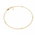 Gold bracelet with small diamond-like stones on a white background