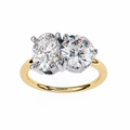 Gold ring with two large diamonds on a white background