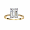 Gold ring with a large emerald-cut diamond and smaller diamonds on the band against a white background