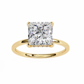 Rose gold ring with a large square-cut diamond on a white background
