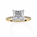 Gold ring with a large diamond and smaller diamonds on the band against a white background
