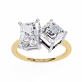 Two diamond earrings on a gold ring with a white background