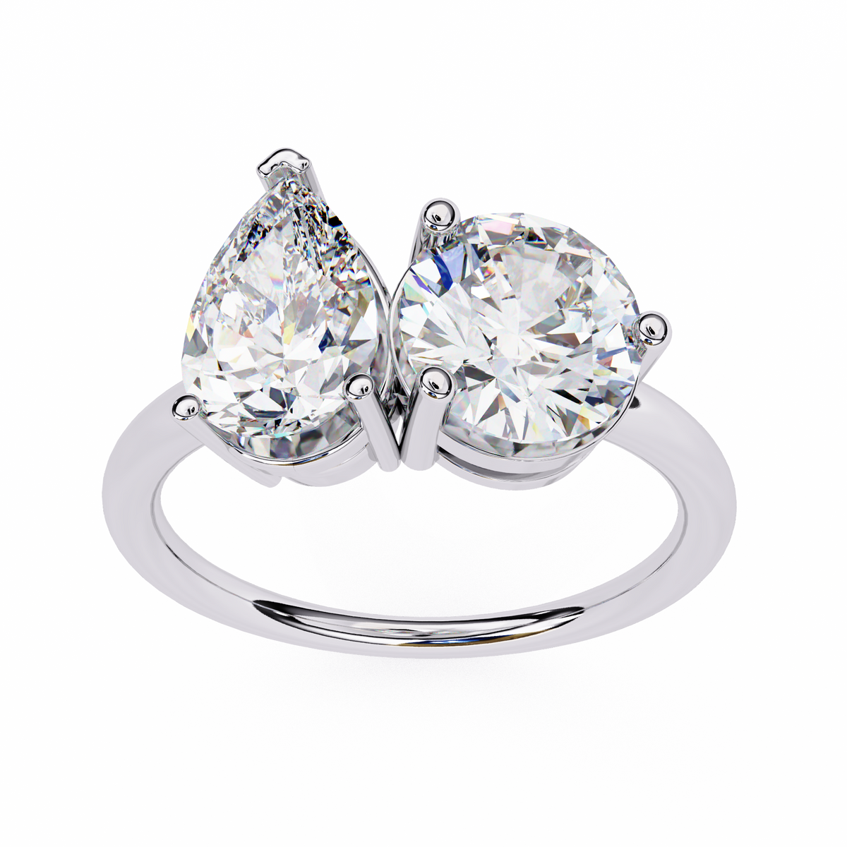Diamond ring with two pear-shaped and one round-cut diamonds on a white background