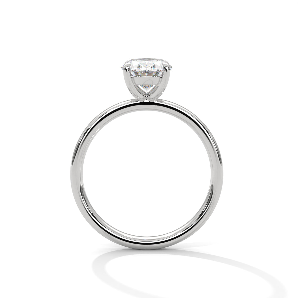 A classic solitaire engagement ring featuring a round brilliant-cut diamond set in a polished white gold or platinum band, shown on a clean white background with a soft reflection.