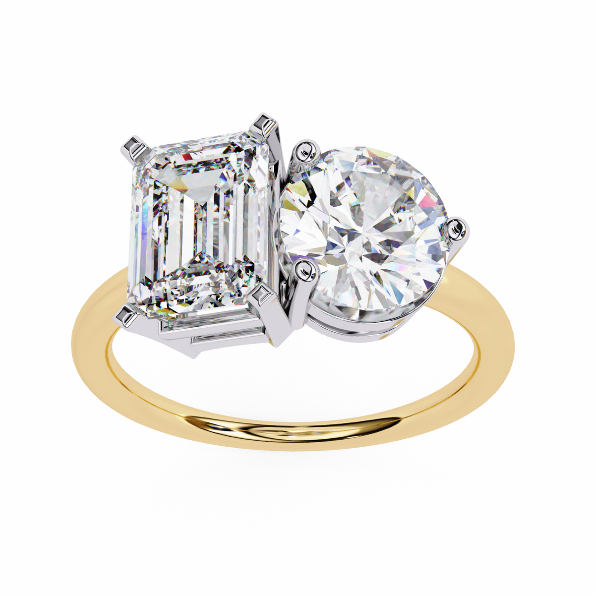 Two-stone diamond ring with emerald-cut and round-cut diamonds on a gold band.